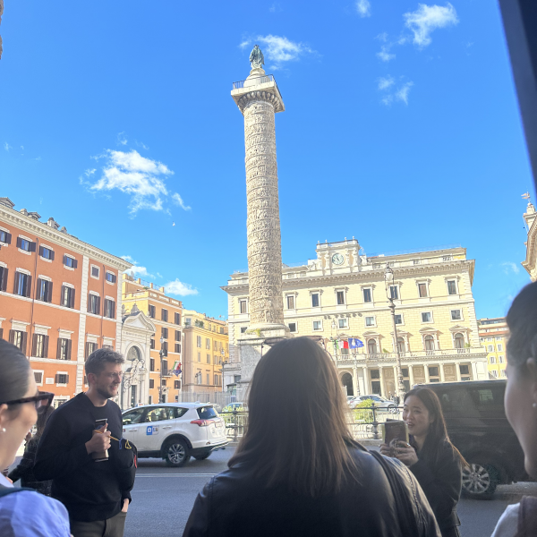 Oli Zhang Presenting in front of the Column of Marcus Aurelius