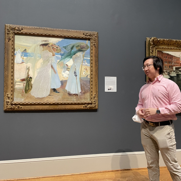 An image of Hoyon Mephokee standing by the Sorolla painting that he discussed in his pop-up talk