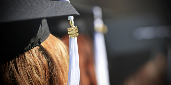 A close-up photo of a student's mortarboard and tassel at a graduation ceremony