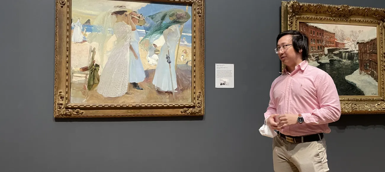 An image of Hoyon Mephokee standing by the Sorolla painting that he discussed in his pop-up talk